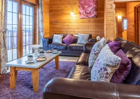 Snow Goose Lodge 16 at Clovelly Lakes, Higher Clovelly is a spacious four-bedroom lakeside retreat nestled within 320 acres of peaceful countryside, featuring a wraparound balcony, complimentary fishing across five lakes, and woodland walks.