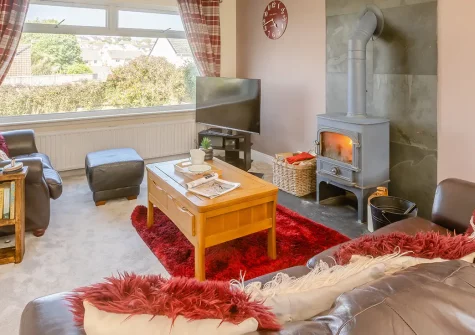 Soundwaves House, Bude is a chic three-bedroom coastal escape just half a mile from stunning beaches. Enjoy cosy interiors with wood burner, lovely enclosed garden with BBQ, and easy access to Cornwall's dramatic coastline and attractions.