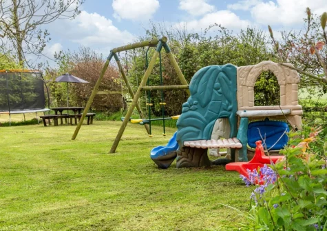 The garden, alfresco dining area & children's play area at South Blatchborough Manor, Bradworthy
