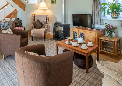 South Woodford, Milton Damerel is a charming converted barn retreat nestled in the North Devon countryside. With four bedrooms, a wood burner, games barn, and pirate-themed play area, it offers the perfect blend of relaxation and adventure.