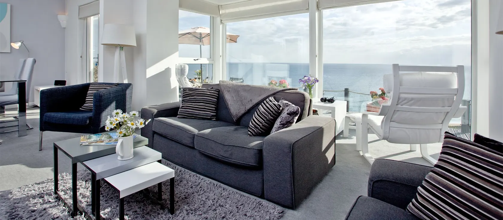 Spindrift, Praa Sands is a luxury clifftop holiday home with stunning sea views. Three bedrooms, two bathrooms, gourmet kitchen & contemporary living room with woodburner. Huge deck with hot tub for alfresco dining & relaxing. Walk to beach.