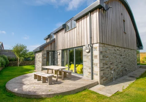 The patio, alfresco dining area & wraparound garden at St Cadoc, Trevone