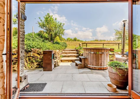 Step out on to the patio, with alfresco dining area & wood burning hot tub