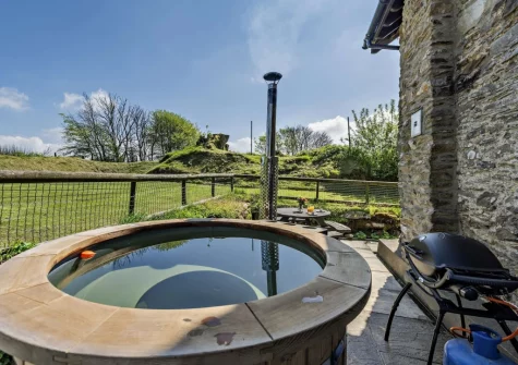 Enjoy soaking in the wood burning hot tub at Stable Cottage, Challacombe