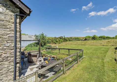 The patio & enclosed lawned garden at Stable Cottage, Challacombe