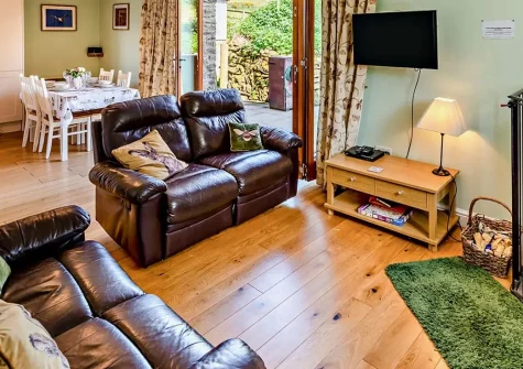 Stable Cottage, Challacombe is a charming detached barn conversion on a 1500-acre working farm, featuring a luxurious wood-fired hot tub, beautiful countryside views, and direct access to Exmoor's wild moorlands and North Devon's golden beaches.