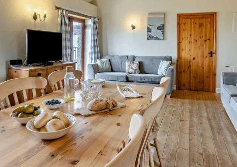 Stanbury Cottage at Cory Farm, Gooseham is a spacious four-bedroom barn conversion on a 267-acre organic dairy farm, with sea views towards Lundy Island, a shared garden, wood burner and easy access to North Cornwall's beaches and coast path.