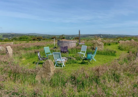 The shared garden area, with firepit & wood fired hot tub, at Standing Stones, Newlyn