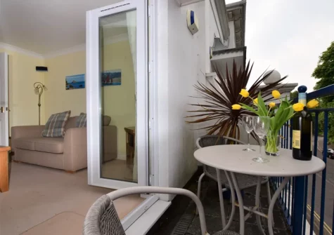 The living room & balcony at Starboard, Hesketh Mews, Torquay