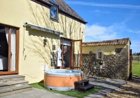 The patio, outdoor sitting area & hot tub at Stargazey Barn, Buckland Brewer
