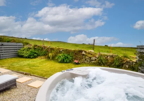 The terrace, hot tub & enclosed gaden at Stargazing Cottage, St Just
