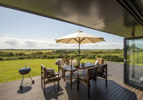 The decked patio, barbecue & alfresco dining area at Stargazy, Morcliff Holiday Lodges, St Agnes