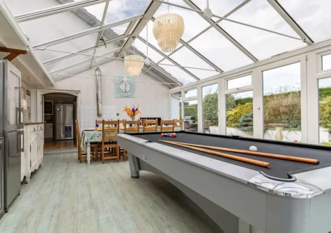 The conservatory with American-style pool table at Stonewold, Buckland Brewer