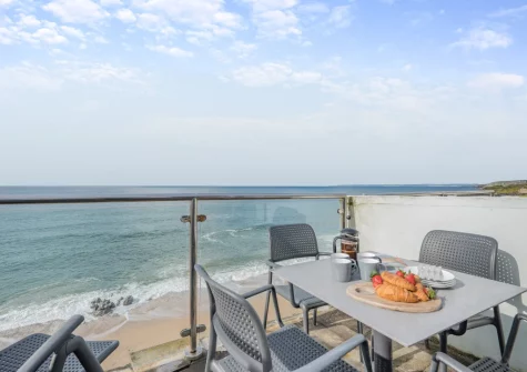 The sunroom balcony & outdoor sitting area at Stormgazer, Porthleven