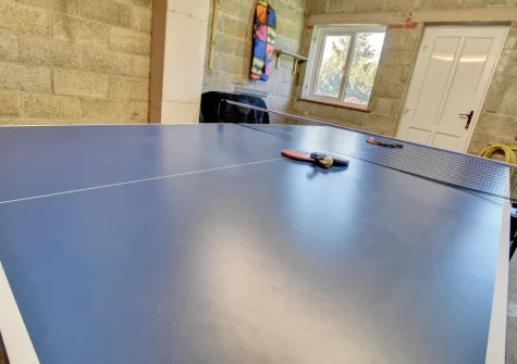 The garage, with table tennis table & storage area, at Sundowner, Croyde