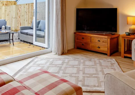 Sunny View, Appledore is a modern two-bedroom cottage on the tranquil outskirts of this historic fishing village, featuring a private enclosed garden with barbecue, coastal interiors, and easy access to golden beaches and the Tarka Trail.