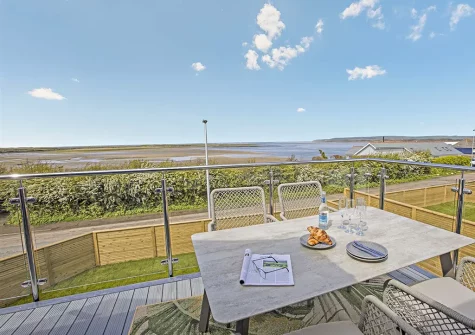 The decked balcony & alfresco dining area at Sunset Bay, Appledore