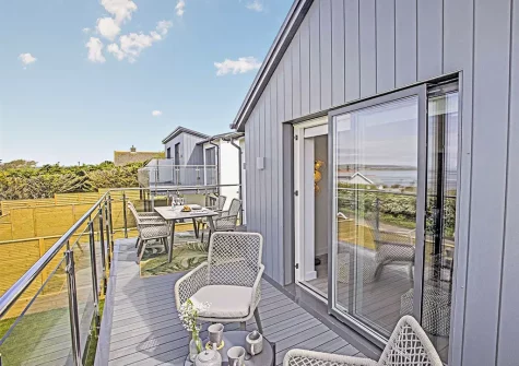 The decked balcony & alfresco dining area at Sunset Bay, Appledore