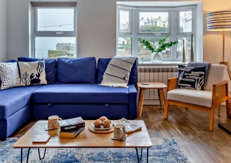 Surf View, Porthleven is a delightful harbourside cottage in the heart of this enchanting fishing village, featuring glorious sea and harbour views from the living room and bedrooms, a cosy wood burner, and the beach just moments from your door.