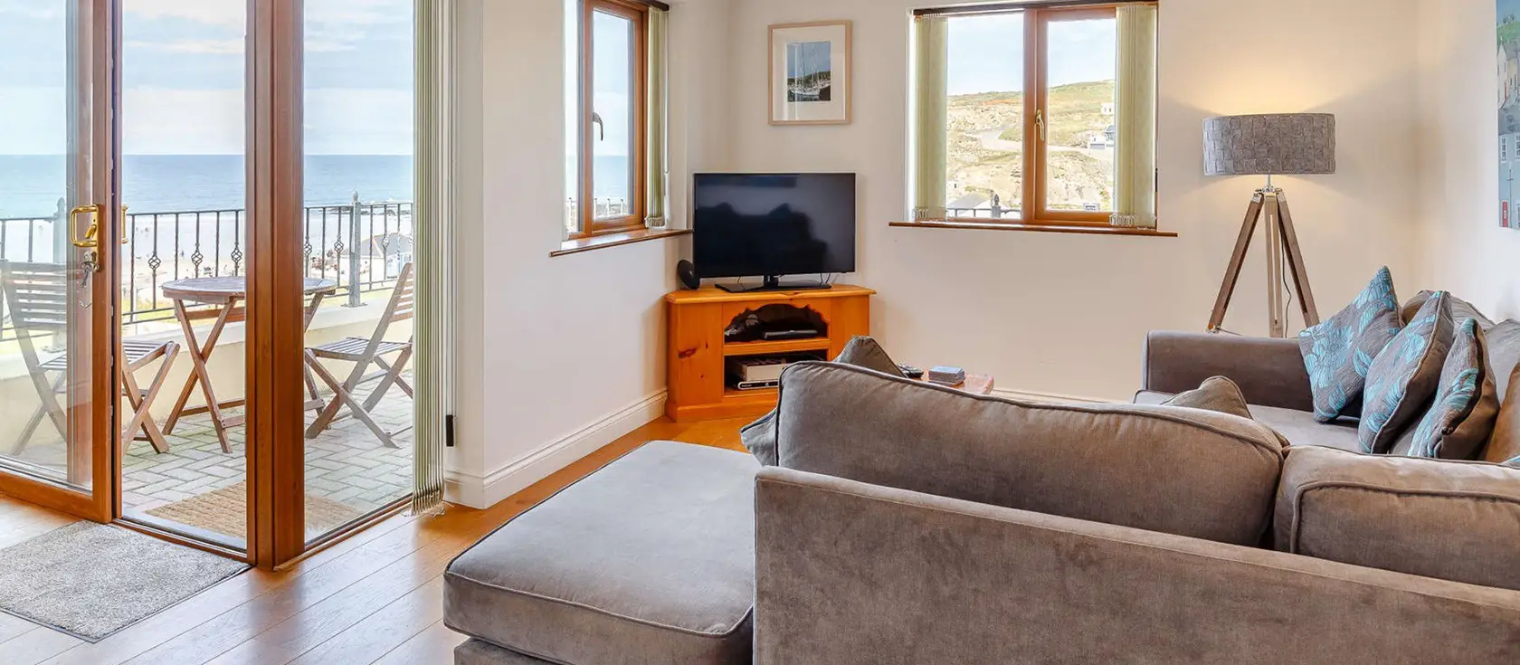 Surfers, Portreath is a stylish two-bedroom apartment mere steps from a golden sandy beach. Enjoy panoramic sea views from your contemporary living space & private patio while being perfectly positioned to explore Cornwall's coastline & attractions.