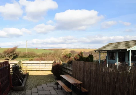 The enclosed tiered suntrap patio & outdoor sitting area at Surf's Up, Widemouth Bay
