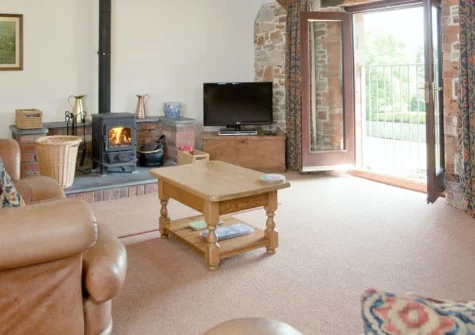 Swallows Cottage, Alwington is a characterful converted stone barn set in peaceful North Devon countryside, featuring three en-suite bedrooms, beamed living spaces with a woodburner, enclosed gardens with play area, and easy access to coastal paths.