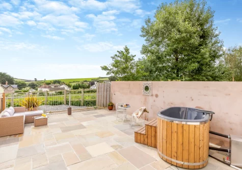 The large enclosed patio, outdoor sitting area & hot tub at Swallows Nest, Ford