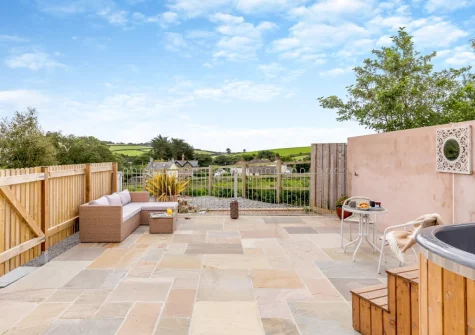 The large enclosed patio, outdoor sitting area & hot tub at Swallows Nest, Ford