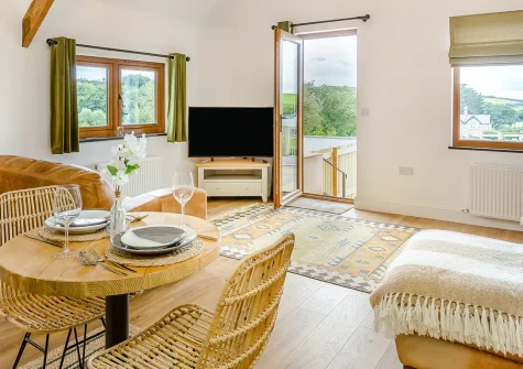 Swallows Nest, Ford is a beautifully renovated one-bedroom barn conversion in the North Devon countryside. With a wood-fired hot tub, stylish interiors, and easy access to golden beaches and pretty villages, it's the perfect rural retreat.