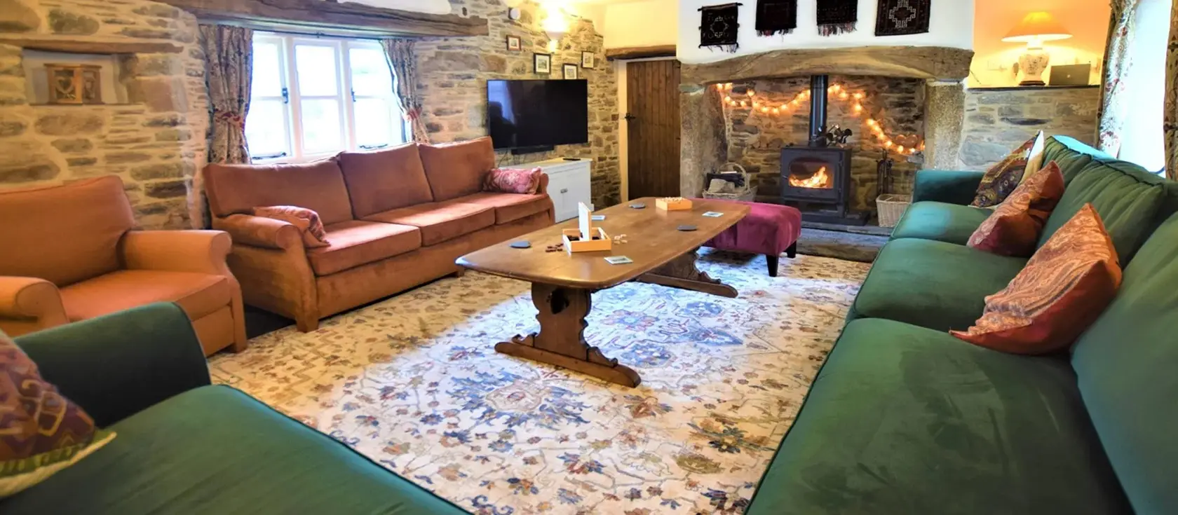 Swallows Rest, Laneast is a stunning converted barn sleeping 16, featuring exposed stone walls, wooden beams, games barn with pool table and table tennis, pizza oven, and easy access to Jamaica Inn, Launceston Castle, and Cornwall's rich heritage.