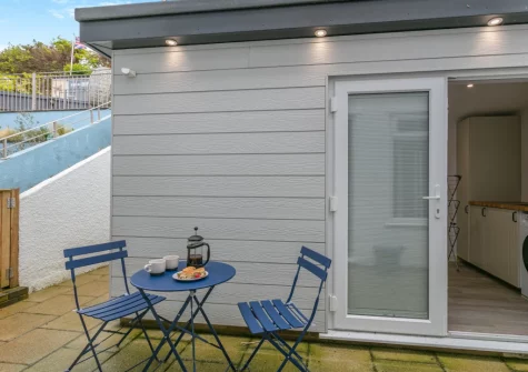 The paved courtyard & outdoor sitting area at Syringa, Beer