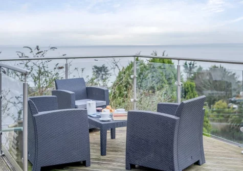 Enjoy far reaching sea views from the decked patio & outdoor sitting area at Tamarisk, Downderry