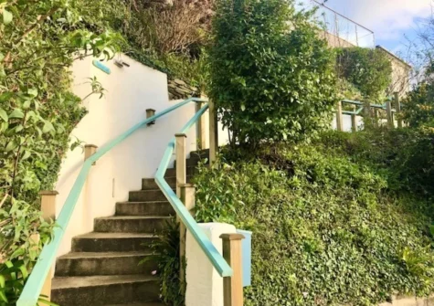 A meandering pathway leads you to the property through the front garden