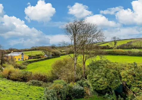 The balcony overlooks a beautiful valley with trickling stream below