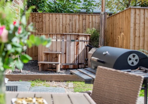 The patio, barbecue, alfresco dining area, wood fired hot tub & garden at Tawnawood, Fletchersbridge