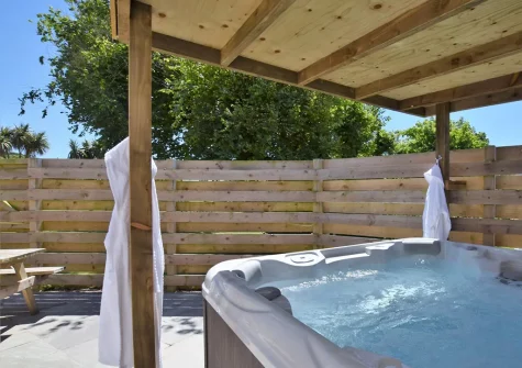 The patio, hot tub, barbecue & alfresco dining area at Teg Gwel Cottage, Cubert