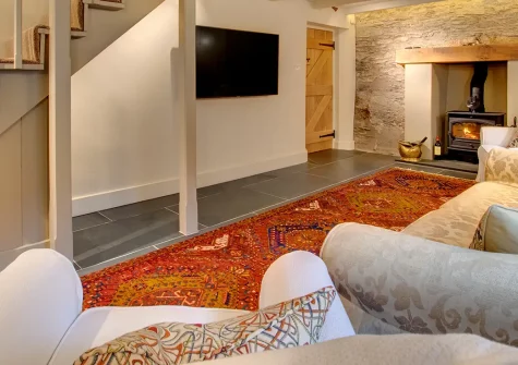 The Ancient Cottage, Looe is a charming four-bedroom stone cottage for eight in leafy grounds with riverside and woodland views. Perfect for family gatherings, it combines country charm with modern comforts and easy access to Cornish beaches.