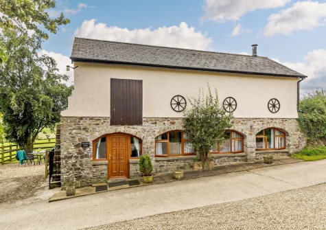 Bordering the scenic Exmoor National Park, The Arch Barn is stunning reverse-level rural detached barn conversion with lovely features including arched windows & a wood burner