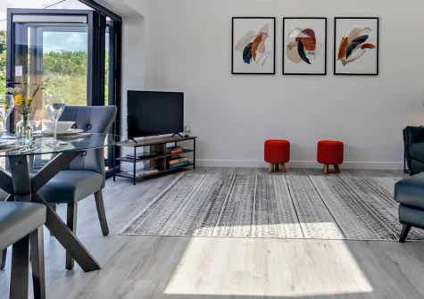 The Barn at Manor Meadows, Radnor is a beautifully converted couples' retreat in peaceful countryside near Truro, featuring bi-fold doors opening onto private decking, sophisticated interiors, and easy access to both golden beaches and rural trails.