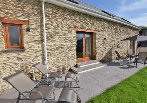 The patio, alfresco dining & outdoor sitting area at The Barn, Moules Farm, Berrynarbor