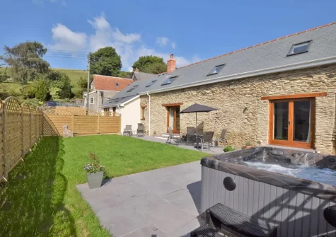 The patio, garden & hot tub at The Barn, Moules Farm, Berrynarbor
