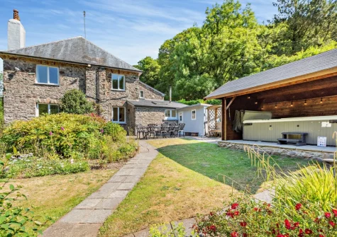 The patio, alfresco dining area & hot tub at The Barton, Martinhoe