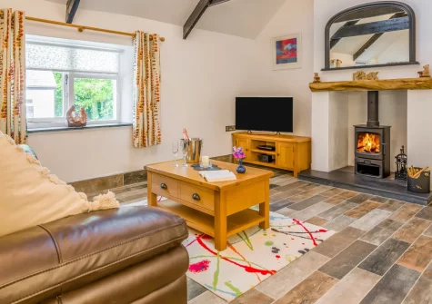 The Bearoak Shippon, Michaelstow is a romantic one-bedroom cottage tucked deep in rural Cornwall, featuring vaulted ceilings, original features, a cosy wood burner, and a private patio, with Port Isaac and the Camel Trail just a short drive away.