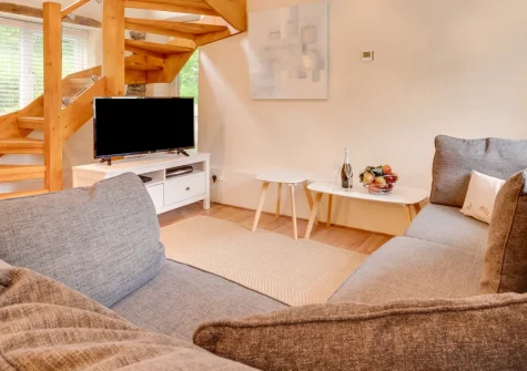 The Big Barn at Well Cottage, Jacobstow is a spacious four-bedroom countryside retreat set in peaceful rural surroundings just five miles from North Cornwall's dramatic coast, featuring beautiful traditional interiors, generous living spaces.