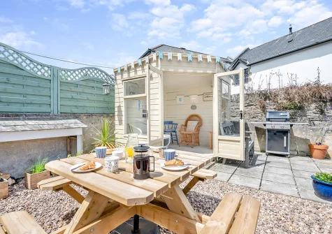 The enclosed patio, barbecue, alfresco dining area & summer house at The Blue House, 18 Glynn Road, Padstow
