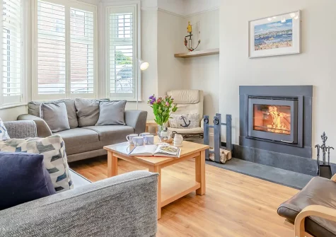 The Blue House, Padstow is a charming three-storey family retreat offering estuary views and rustic elegance. Enjoy a cosy wood burner, enclosed patio with delightful summerhouse, and easy access to Padstow's renowned seafood restaurants.