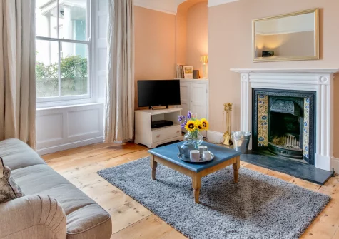 The Blue House, Penzance is an elegant Grade II-listed family home in peaceful Regent Square, featuring high-ceilinged period rooms, a charming enclosed garden, and an enviable location between Penzance seafront and the town centre.