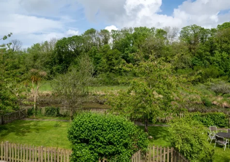 The large enclosed garden at The Boathouse has gated access to the creek