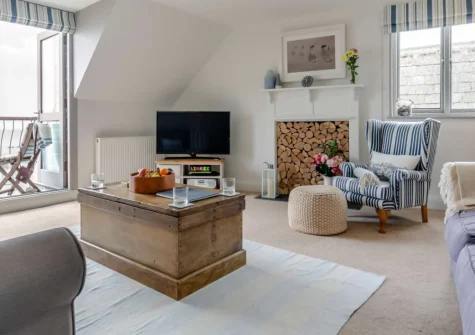 The Bolt Hole at Admiralty Court, Looe is a luxurious top-floor apartment with stunning panoramic sea views from two private balconies, contemporary coastal interiors, dedicated parking, and the beach just steps from your door in the heart of town.