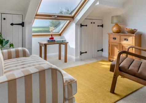 The Byre, Tresmeer is a charming detached cottage for two, tucked into peaceful Cornish countryside with a private hot tub, sweeping rural views, and easy access to cycle routes, coastal villages and the surfing beaches of Bude and Widemouth Bay.